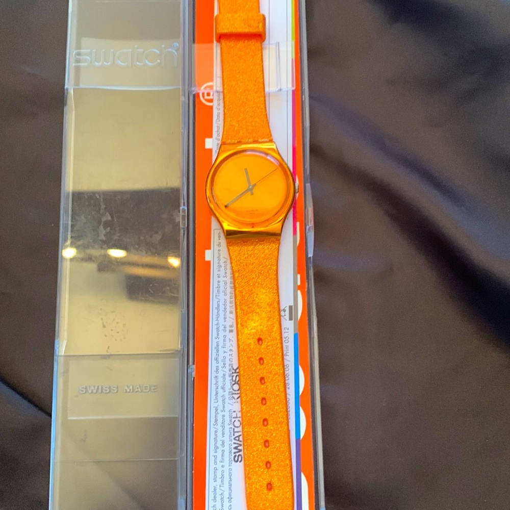 Brand New Swatch Watch. In a Great Colour.it has a sparkling band with an orange